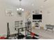 Bright dining area with a glass table set, a modern chandelier, and built in shelving for entertainment at 4044 S Salford Blvd, North Port, FL 34287