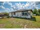 Charming single-story home featuring a well-manicured lawn and beautiful landscaping at 4044 S Salford Blvd, North Port, FL 34287
