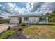 Charming home exterior with well-maintained landscaping and a two-car garage at 4044 S Salford Blvd, North Port, FL 34287