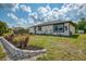 Charming home exterior with well-maintained landscaping and a lawn at 4044 S Salford Blvd, North Port, FL 34287