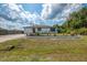 Charming single-story home with a well-manicured lawn, attractive landscaping, and a driveway leading to an attached garage at 4044 S Salford Blvd, North Port, FL 34287