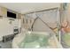 A close view of a hot tub on a screened patio with a TV, perfect for relaxation at 4044 S Salford Blvd, North Port, FL 34287