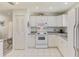 Efficient kitchen with white cabinets, updated appliances, and a pantry for storage at 4044 S Salford Blvd, North Port, FL 34287