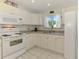 Bright kitchen with white cabinets, countertops and appliances with a window for natural light at 4044 S Salford Blvd, North Port, FL 34287