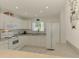 Bright kitchen with white cabinets, countertops and appliances with a window for natural light at 4044 S Salford Blvd, North Port, FL 34287