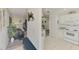 Bright living room with white walls, decorative hanging chair, and an open view to the kitchen at 4044 S Salford Blvd, North Port, FL 34287