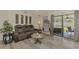 Cozy living room with modern furniture, hanging chair, and sliding glass doors leading to an outdoor space at 4044 S Salford Blvd, North Port, FL 34287