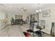 Inviting living room with ceiling fan, dining area, modern furniture, and sliding glass door to the outside at 4044 S Salford Blvd, North Port, FL 34287