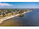Picturesque aerial view of the neighborhood with waterfront homes and a charming pier stretching into the bay at 4089 Yucatan Cir, Port Charlotte, FL 33948