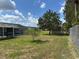 Fenced in backyard with in ground pool, shed, and mature trees at 4089 Yucatan Cir, Port Charlotte, FL 33948