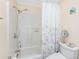 Cozy bathroom with white shower-tub, floral curtain, and decorative beach themed accents at 4089 Yucatan Cir, Port Charlotte, FL 33948