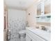 Bright bathroom featuring a vanity, commode, and shower with matching decor at 4089 Yucatan Cir, Port Charlotte, FL 33948
