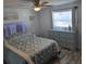 Bright bedroom with stylish dresser, ceiling fan and large bed at 4089 Yucatan Cir, Port Charlotte, FL 33948