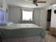 Inviting bedroom with soft blue tones, dresser and a comfortable bed and ensuite at 4089 Yucatan Cir, Port Charlotte, FL 33948