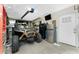 Spacious garage featuring an ATV, tools, storage, and a refrigerator, providing ample space for hobbies and projects at 4089 Yucatan Cir, Port Charlotte, FL 33948