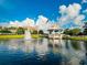 Beautiful view of gazebo with a fountain on the water and lush greenery and blue sky at 4089 Yucatan Cir, Port Charlotte, FL 33948