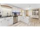 Well-lit kitchen featuring white cabinetry, granite countertops, stainless steel appliances, and modern fixtures at 4089 Yucatan Cir, Port Charlotte, FL 33948