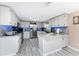 Modern kitchen featuring stainless steel appliances, white cabinetry, granite countertops, and ample counter space at 4089 Yucatan Cir, Port Charlotte, FL 33948