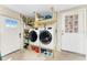 Laundry room including a stacked washer and dryer, storage shelves, and access to exterior doors at 4089 Yucatan Cir, Port Charlotte, FL 33948