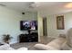 Comfortable living room with wood flooring, light green walls, and a modern TV set for relaxing entertainment at 4089 Yucatan Cir, Port Charlotte, FL 33948