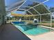 Screened in-ground pool with attached sun shade at 4089 Yucatan Cir, Port Charlotte, FL 33948