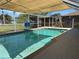 Inviting outdoor pool with a screen enclosure and poolside shower at 4089 Yucatan Cir, Port Charlotte, FL 33948