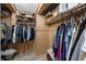 Walk-in closet with shelving and hanging racks for ample storage, with wood paneled walls and light wood floor at 4089 Yucatan Cir, Port Charlotte, FL 33948