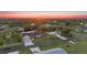 Beautiful aerial view of home with spacious yard, detached garage, and lovely sunset at 4317 Mccullough St, Port Charlotte, FL 33948