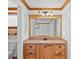A bathroom vanity with a wooden frame and a large mirror that brightens the room with natural light at 4317 Mccullough St, Port Charlotte, FL 33948