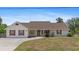 Well-maintained single-story home with a lush green lawn and mature landscaping at 4317 Mccullough St, Port Charlotte, FL 33948