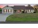 Charming single-story home with a well-manicured lawn, brown shutters, and inviting entryway at 4317 Mccullough St, Port Charlotte, FL 33948