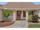 Charming front porch with brick accents, white railings, and vibrant landscaping at 4317 Mccullough St, Port Charlotte, FL 33948