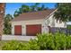 Spacious two-car garage with traditional doors and adjacent yard at 4317 Mccullough St, Port Charlotte, FL 33948