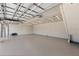 Spacious garage interior with white walls, overhead lights, ceiling fan and a metal garage door track at 4317 Mccullough St, Port Charlotte, FL 33948
