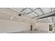 Interior of the large garage with white walls, overhead lighting, and a staircase at 4317 Mccullough St, Port Charlotte, FL 33948