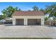 Detached two-car garage with a concrete driveway and staircase leading to additional storage space at 4317 Mccullough St, Port Charlotte, FL 33948