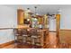 Kitchen with wood cabinets, granite countertops, stainless appliances, and an island with seating at 4317 Mccullough St, Port Charlotte, FL 33948