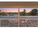 A lanai view features colorful sunset views over the screened-in pool area and tropical foliage at 4317 Mccullough St, Port Charlotte, FL 33948
