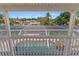 A covered lanai features a view of the screened-in pool area and tropical foliage at 4317 Mccullough St, Port Charlotte, FL 33948