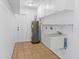 Functional laundry room with ample storage, utility sink, and convenient water heater at 4317 Mccullough St, Port Charlotte, FL 33948
