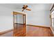 Bright living room showcasing hardwood floors, ceiling fan, and wooden door and window frames at 4317 Mccullough St, Port Charlotte, FL 33948