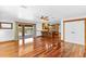 A peek into the kitchen from the living room with gleaming hardwood floors at 4317 Mccullough St, Port Charlotte, FL 33948