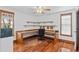 Office space with hardwood floors, large built-in desk, shelving, and natural light at 4317 Mccullough St, Port Charlotte, FL 33948