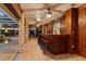 Covered outdoor wooden bar with tile flooring, brick columns, and view of pool at 4317 Mccullough St, Port Charlotte, FL 33948