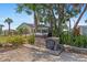 Outdoor brick grill and food prep area surrounded by lush greenery and attractive landscaping at 4317 Mccullough St, Port Charlotte, FL 33948