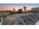 Aerial view of a beautiful screened-in pool and spa area at sunset with palm trees at 4317 Mccullough St, Port Charlotte, FL 33948
