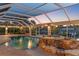 Relaxing screened pool and spa area with beautiful rock features and lush tropical landscaping at 4317 Mccullough St, Port Charlotte, FL 33948