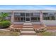Enclosed pool area with steps, planters, and solar panels on top of the enclosure at 4317 Mccullough St, Port Charlotte, FL 33948
