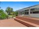 Waterfront home exterior with a private dock, lush landscaping, and screened lanai at 4317 Mccullough St, Port Charlotte, FL 33948