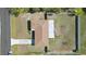 Birds eye view of the home showing the roof, driveway, fenced yard, and surrounding landscaping at 4358 Pates St, Port Charlotte, FL 33948